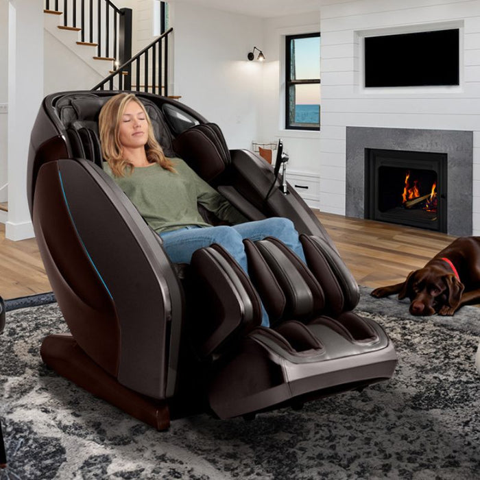 Kyota Hatsumei M900AI 4D Massage Chair in Brown with woman relaxing inside the house.