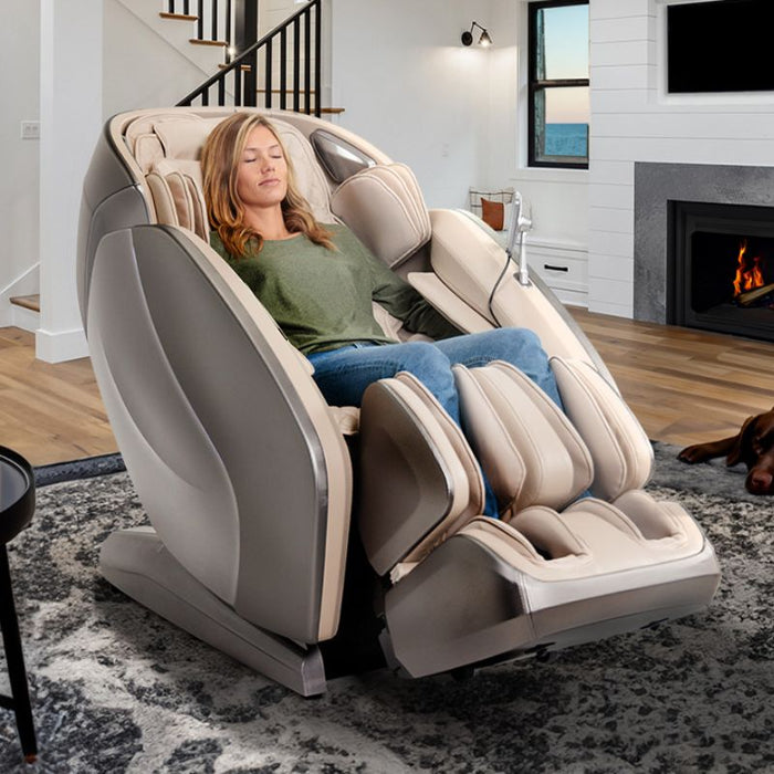 Kyota Hatsumei M900AI 4D Massage Chair in Gray/Tan with woman relaxing.