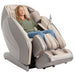 Kyota Hatsumei M900AI 4D Massage Chair in Gray/Tan with woman sitting.