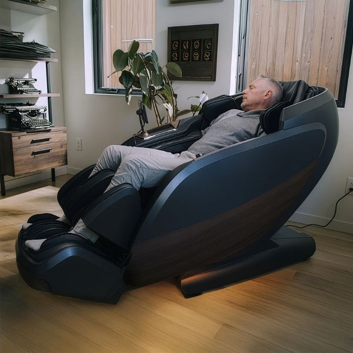 Positive Posture DualTech Pro AI 4D Dual Mechanism Massage Chair with man relaxing.