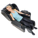 Synca Kurodo E - Premium Commercial Massage Chair with woman sitting in the chair.