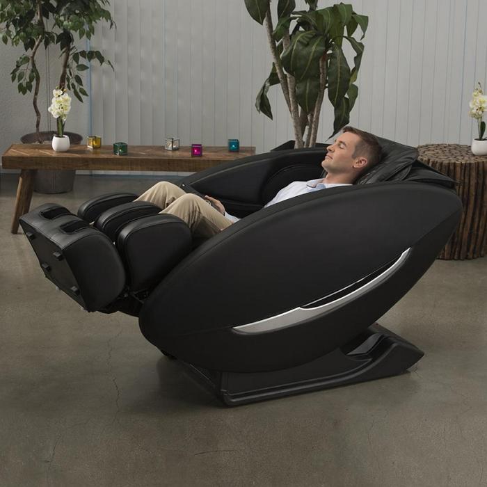 Inner Balance Wellness Ji Massage Chair IMR0047 in fully reclined angled with person in room