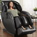 Kyota M673 Kenko Massage Chair in Black with Woman Relaxing