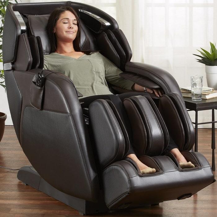 Kyota M673 Kenko Massage Chair in Brown With Woman Relaxing