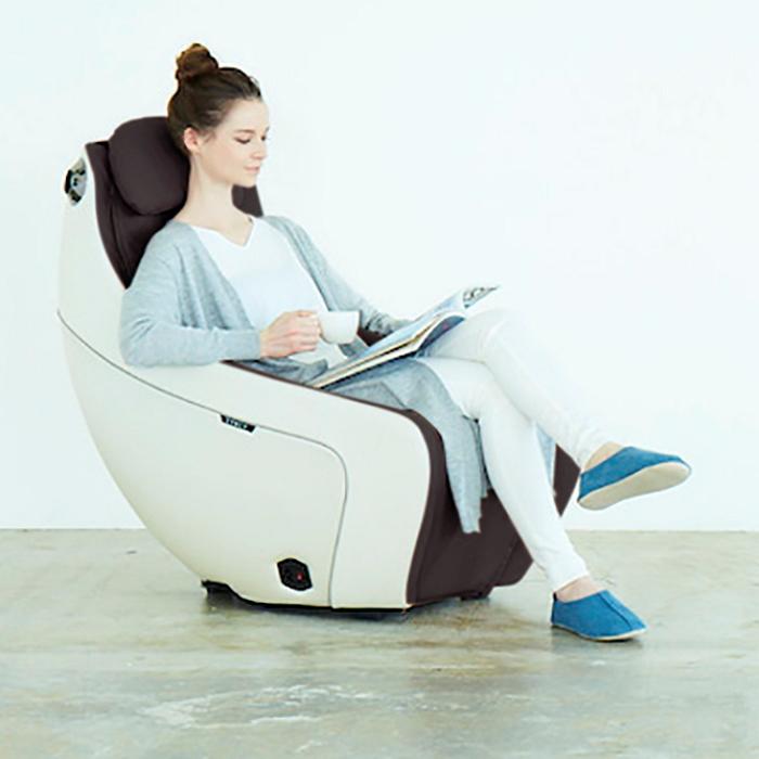 Synca Wellness CirC Massage Chair in coffee with model reading